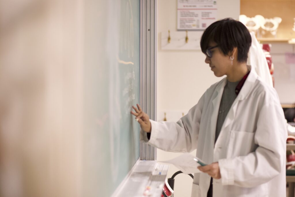Indigenous students in a biology lab at a chalkboard