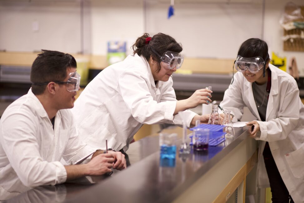 Indigenous students in a biology lab engaged in an experiment.